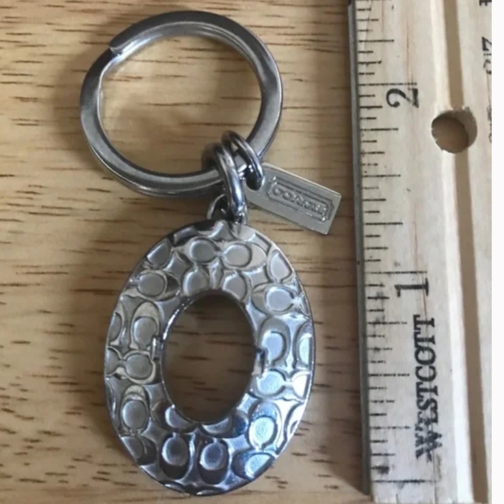 Coach Silver Tone Oval Signature C Embossed Logo Keychain